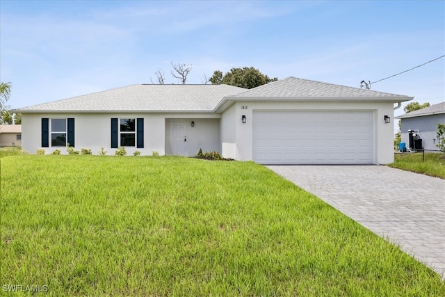 single story home featuring a front lawn and a garage