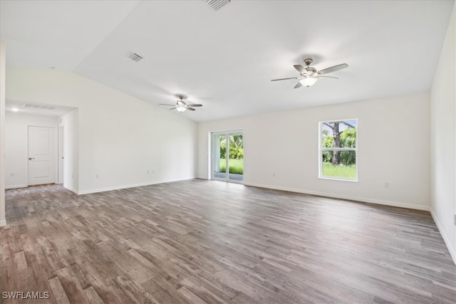 interior space with lofted ceiling, hardwood / wood-style floors, and ceiling fan