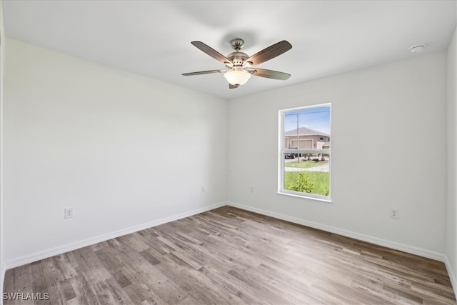 spare room featuring ceiling fan and light hardwood / wood-style flooring