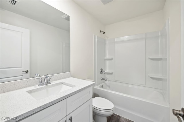 full bathroom with vanity, wood-type flooring, washtub / shower combination, and toilet