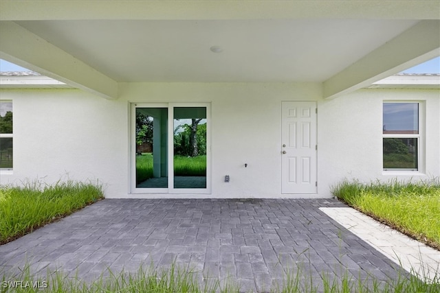 property entrance with a patio area