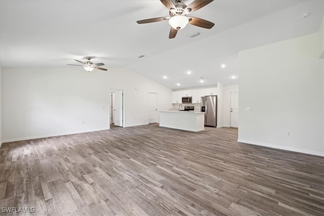 unfurnished living room featuring ceiling fan, hardwood / wood-style flooring, and vaulted ceiling