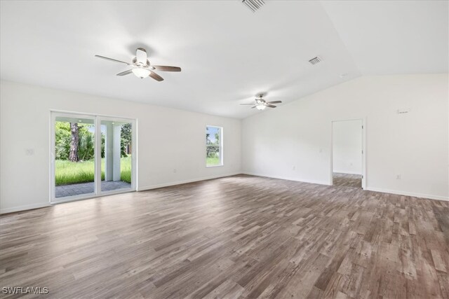 empty room featuring ceiling fan, lofted ceiling, and hardwood / wood-style floors