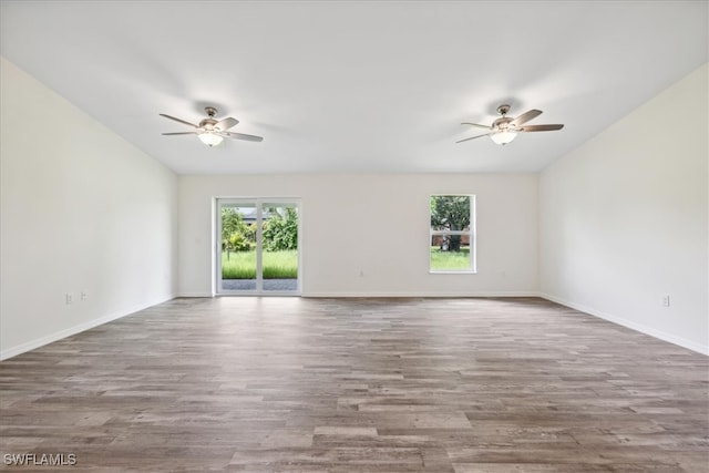 empty room with hardwood / wood-style floors and ceiling fan