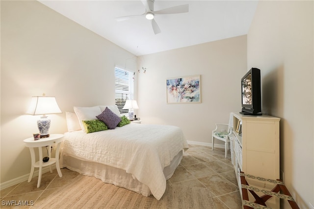 tiled bedroom featuring ceiling fan