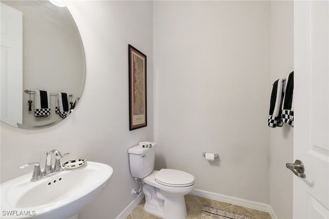 bathroom with tile patterned floors, toilet, and sink