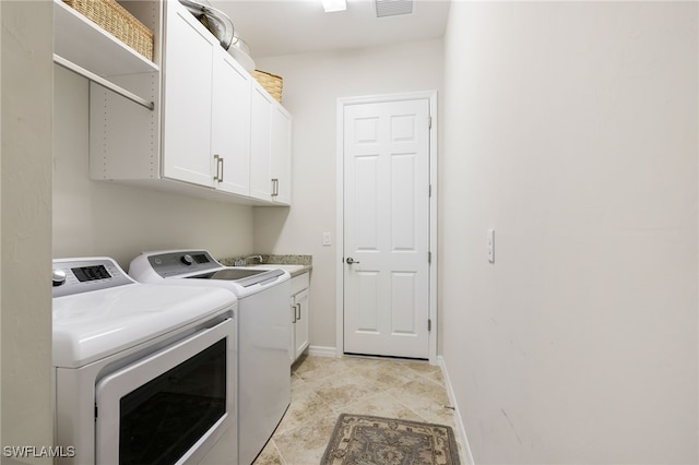 laundry room featuring cabinets, washer and clothes dryer, and sink