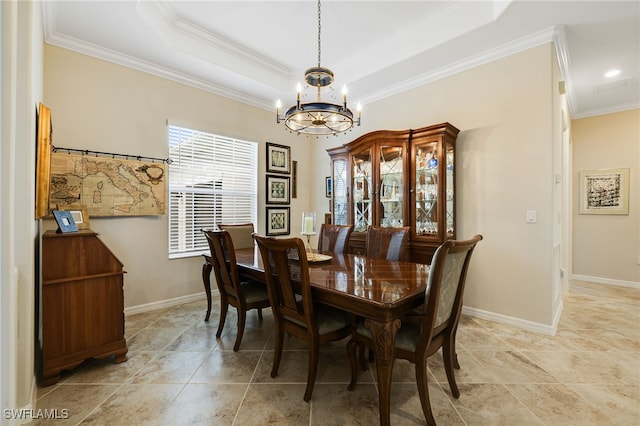 dining space featuring crown molding, a tray ceiling, and an inviting chandelier