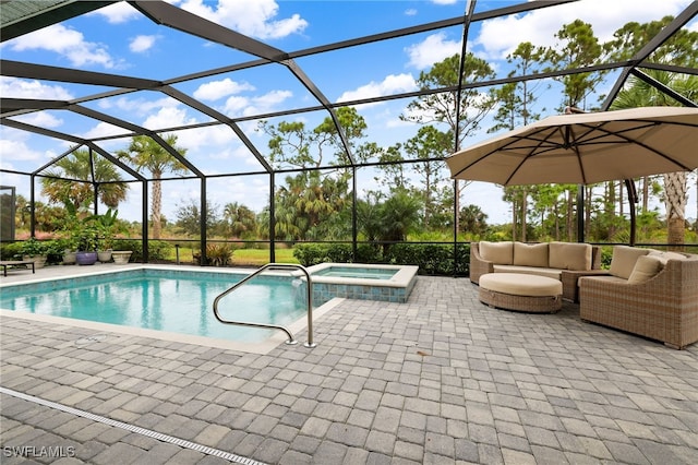 view of pool featuring a lanai, an in ground hot tub, and a patio