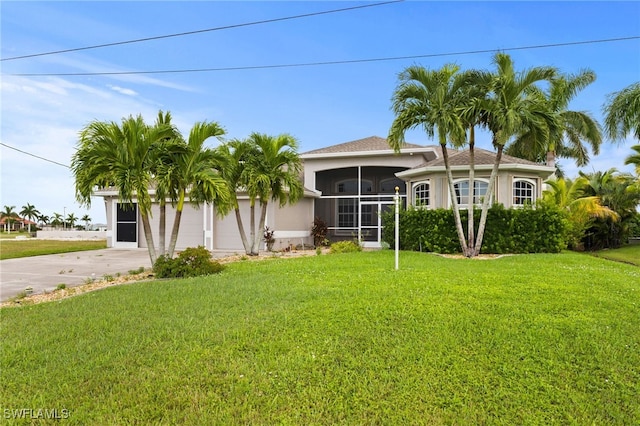 view of front of house featuring a front yard and a sunroom