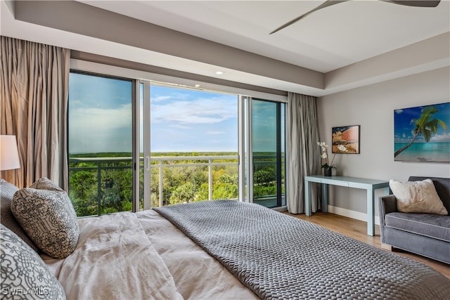 bedroom featuring wood-type flooring and multiple windows