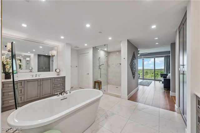 bathroom with vanity, independent shower and bath, and hardwood / wood-style flooring