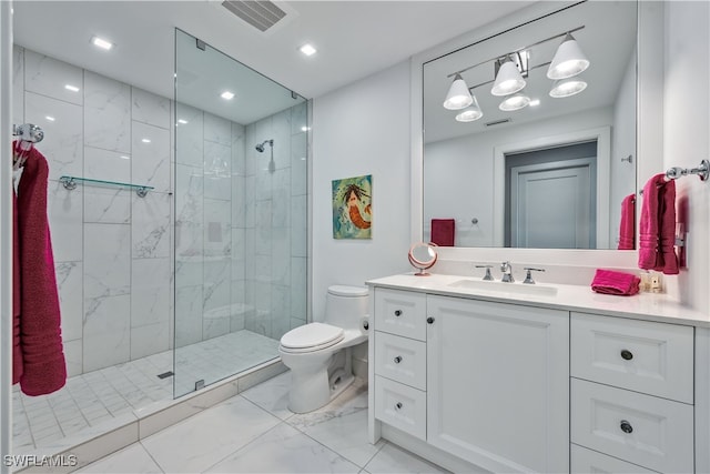 bathroom featuring toilet, a shower with shower door, and vanity