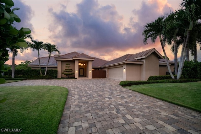 view of front of house featuring a yard and a garage