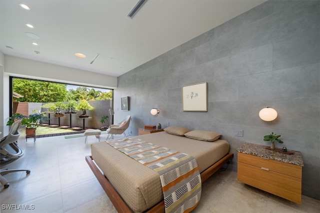 bedroom with tile walls and vaulted ceiling