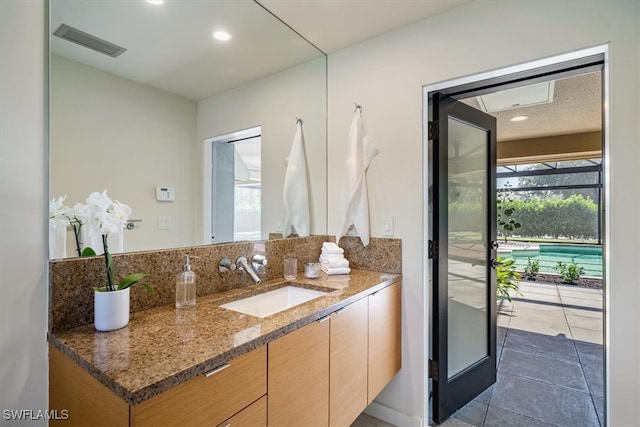 bathroom featuring tile patterned flooring and vanity