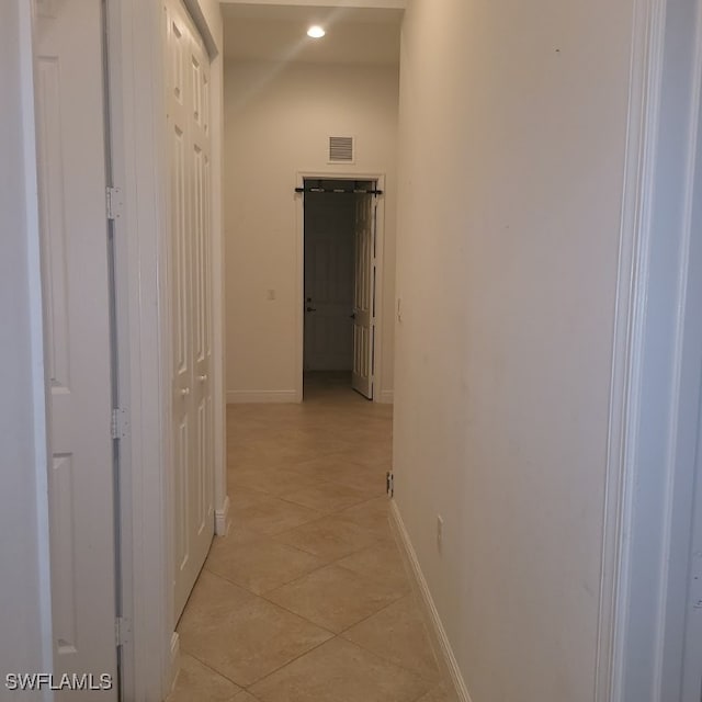 corridor featuring light tile patterned floors