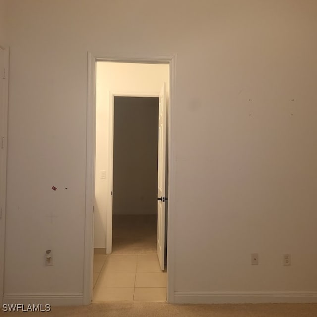 hallway featuring light tile patterned flooring