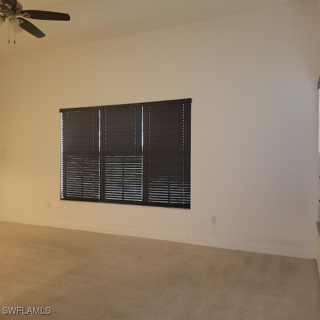 carpeted empty room with ceiling fan