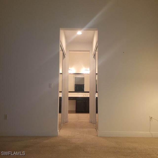 hall featuring light colored carpet