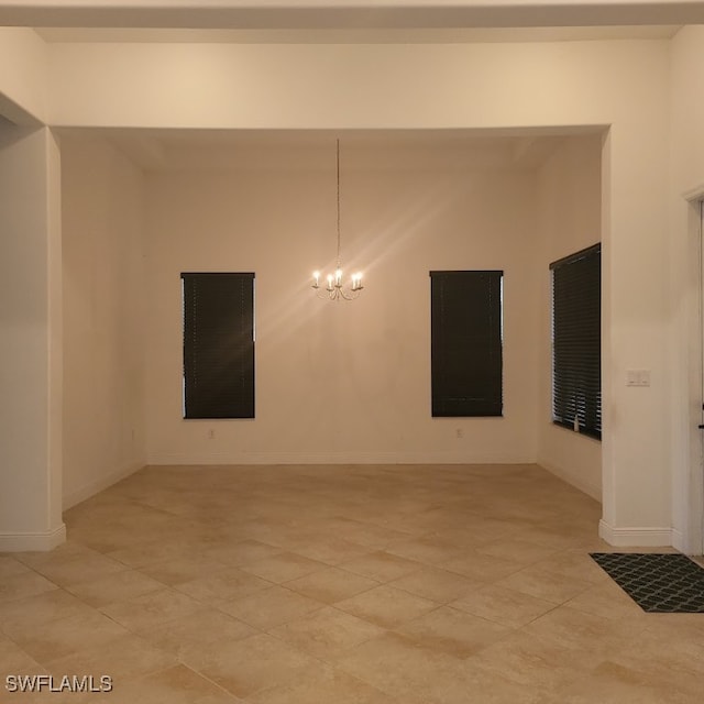 empty room featuring a notable chandelier