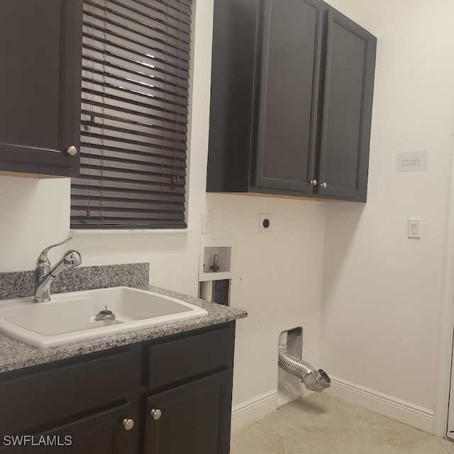 laundry room featuring light tile patterned floors, sink, hookup for an electric dryer, cabinets, and hookup for a washing machine