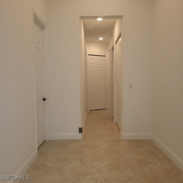 hallway with light tile patterned floors