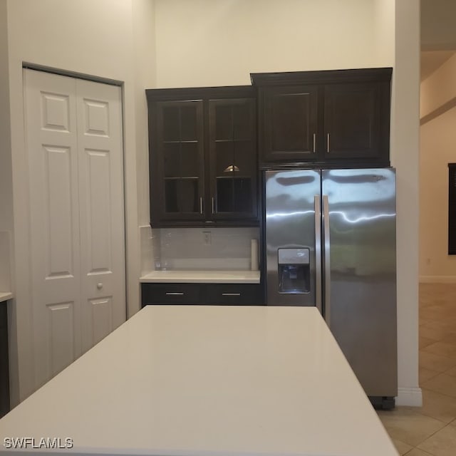 kitchen with light tile patterned flooring and stainless steel fridge with ice dispenser