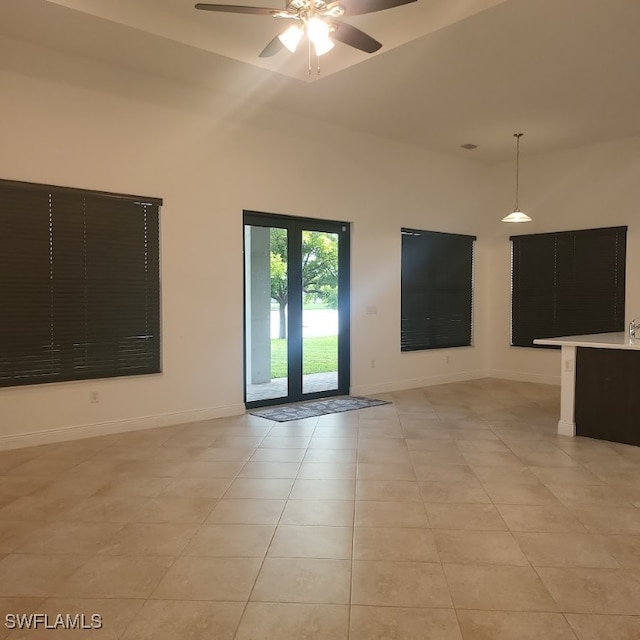 tiled empty room with ceiling fan