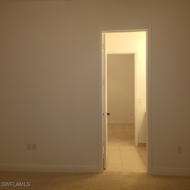 hall featuring light colored carpet