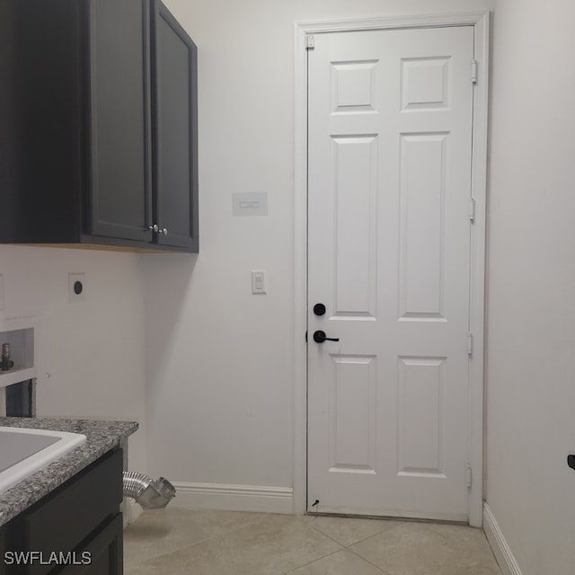 clothes washing area featuring hookup for a washing machine, light tile patterned floors, electric dryer hookup, and cabinets