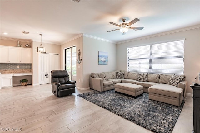 living room with crown molding and ceiling fan