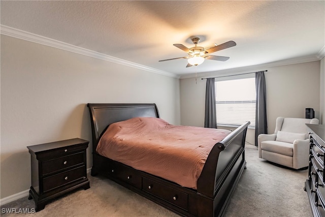 carpeted bedroom featuring a textured ceiling, ornamental molding, and ceiling fan