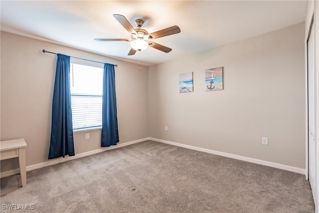 carpeted empty room with ceiling fan