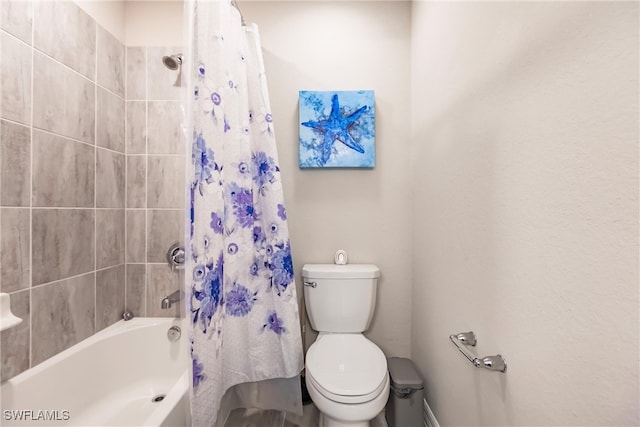 bathroom with shower / bath combo and toilet