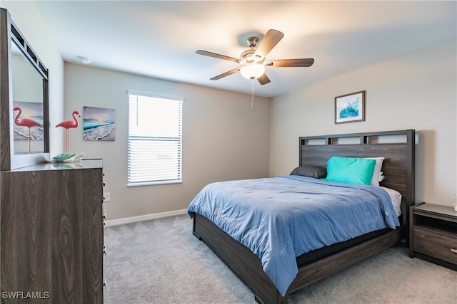 bedroom featuring ceiling fan and light colored carpet