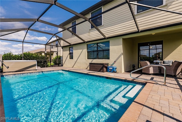 view of swimming pool featuring a lanai and a patio