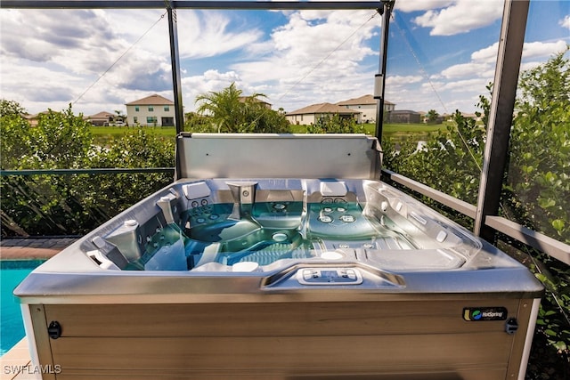 sunroom / solarium with a hot tub