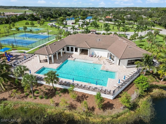 view of swimming pool featuring a patio and tennis court