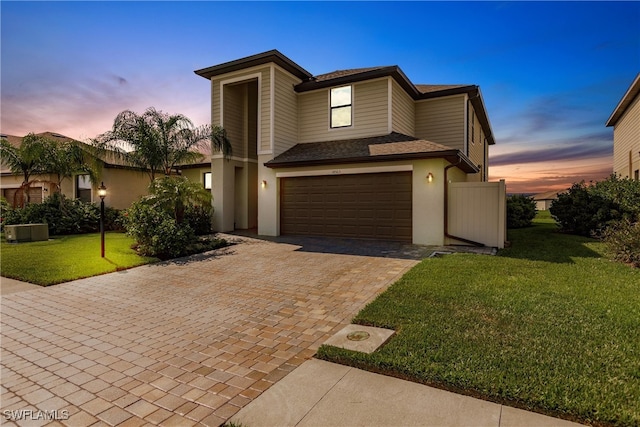 view of front facade featuring a yard and a garage