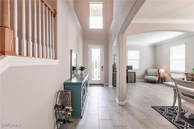 foyer entrance featuring crown molding