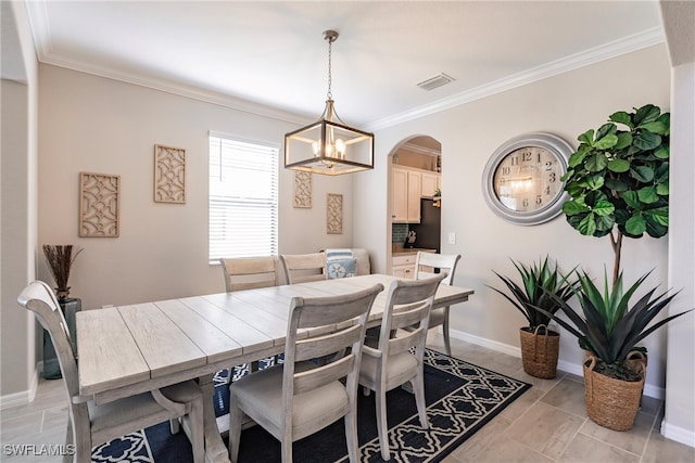 dining space featuring crown molding