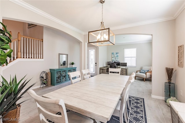 dining space with ornamental molding and a notable chandelier