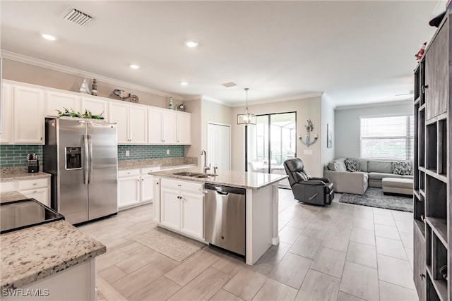 kitchen featuring an island with sink, stainless steel appliances, white cabinetry, and sink