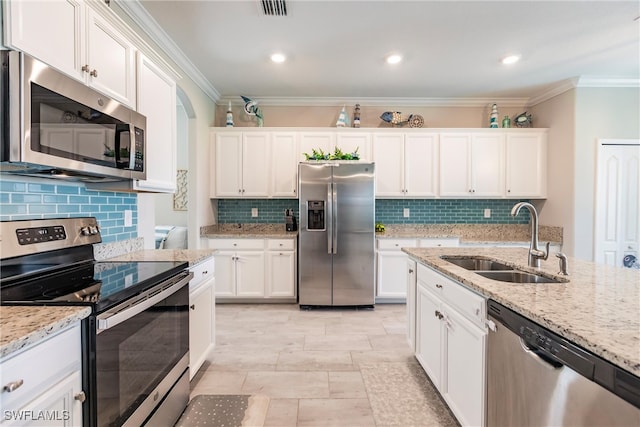 kitchen featuring light stone counters, sink, white cabinets, appliances with stainless steel finishes, and crown molding