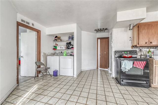 kitchen with independent washer and dryer, backsplash, and black electric range oven