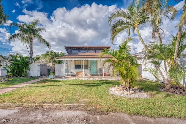 rear view of property featuring a lawn