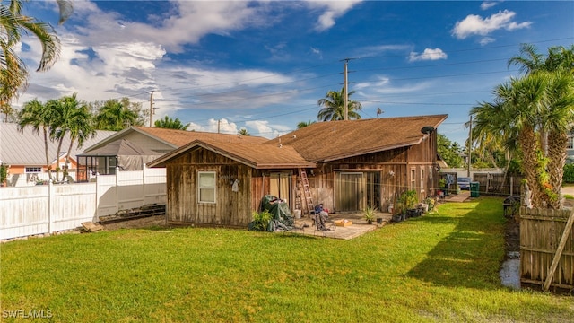 back of property featuring a lawn