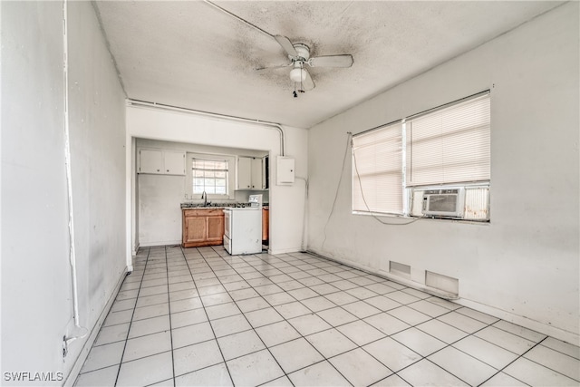 kitchen featuring ceiling fan, cooling unit, sink, light tile patterned floors, and white range oven