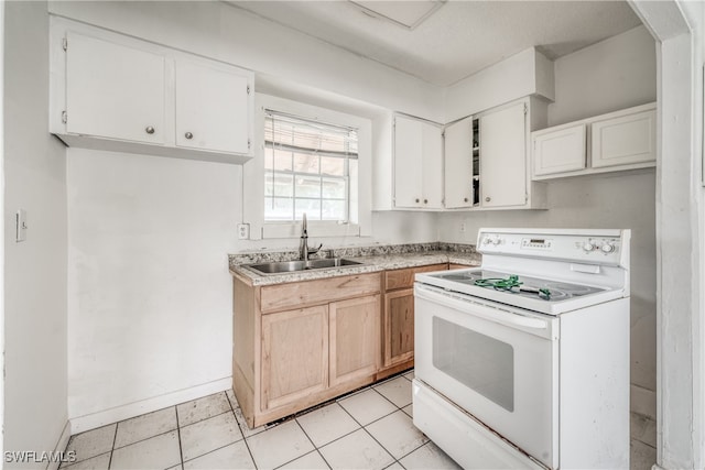 kitchen with electric range, sink, light tile patterned floors, and white cabinetry